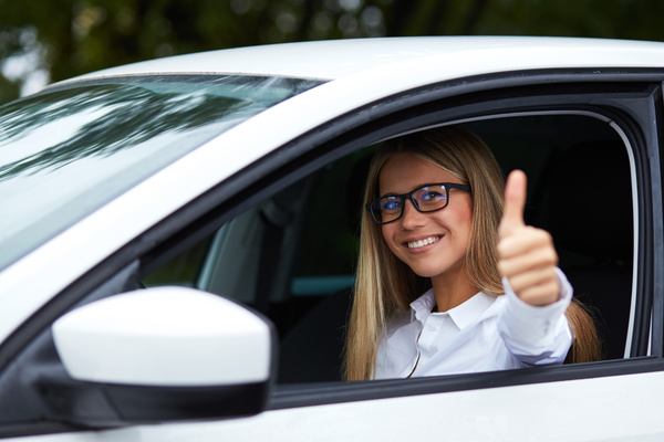Female driver with thumbs up Stock Photo