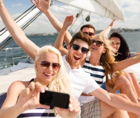 Friends on the yacht with a mobile phone selfie Stock Photo