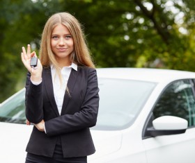 Girl holding car key in front of the car Stock Photo 02