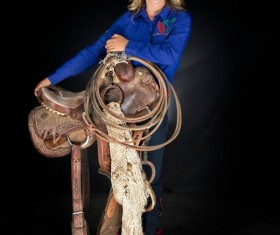 Girl holding saddle Stock Photo
