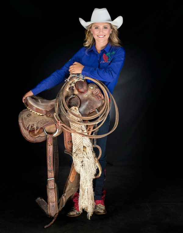 Girl holding saddle Stock Photo