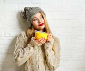 Girl in sweater coat drinking coffee Stock Photo