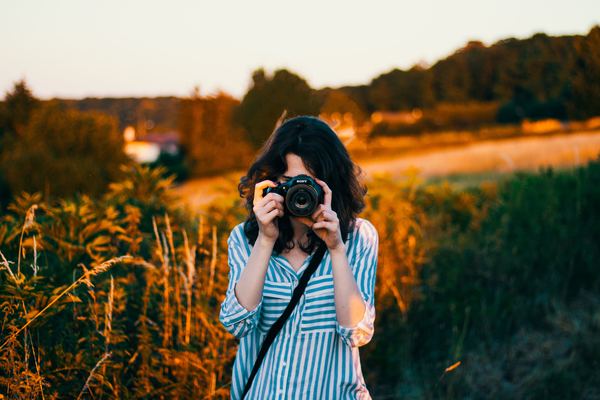Girl photographed with camera Stock Photo