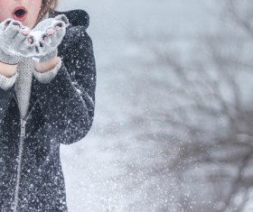 Girl playing with snow outdoor in winter Stock Photo