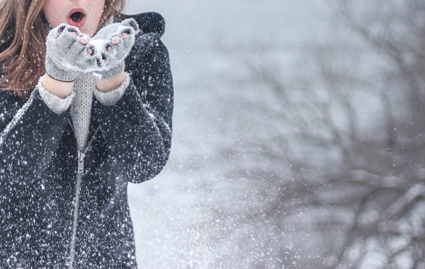Girl playing with snow outdoor in winter Stock Photo