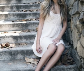 Girl sitting on the steps Stock Photo