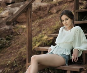 Girl sitting on wooden steps Stock Photo