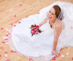 Happy bride sitting on the floor Stock Photo