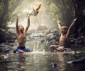 Happy children playing in the creek Stock Photo