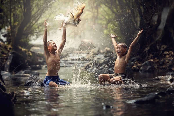 Happy children playing in the creek Stock Photo