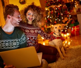 Happy couple and pet dog on Christmas night Stock Photo