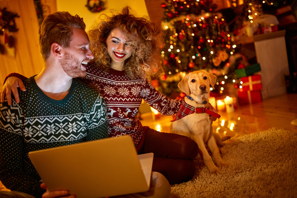 Happy couple and pet dog on Christmas night Stock Photo