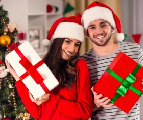 Happy couple holding Christmas gift Stock Photo