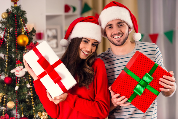 Happy couple holding Christmas gift Stock Photo