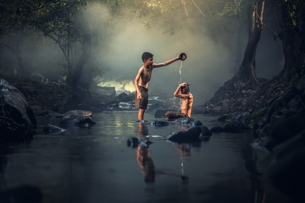 Help each other in the creek bathing kids Stock Photo