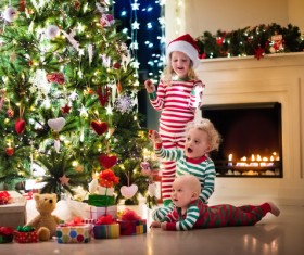 Kids happy before the Christmas tree Stock Photo 01