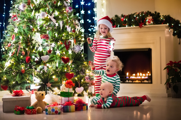 Kids happy before the Christmas tree Stock Photo 01