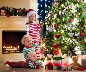 Kids happy before the Christmas tree Stock Photo 02