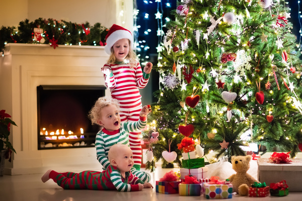 Kids happy before the Christmas tree Stock Photo 02