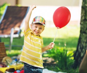 Little boy holding a balloon Stock Photo