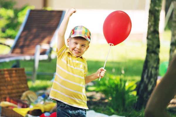 Little boy holding a balloon Stock Photo