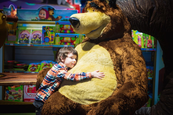 Little boy hugging teddy bear Stock Photo