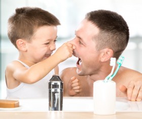 Little boy pinching fathers nose Stock Photo