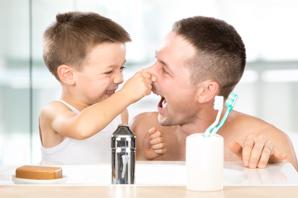 Little boy pinching fathers nose Stock Photo