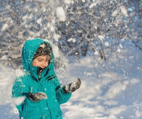 Little boy playing with snow outdoors Stock Photo