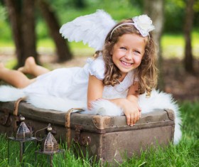 Little girl lying on the suitcase Stock Photo