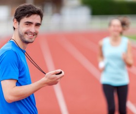 Male coach holding stopwatch Stock Photo