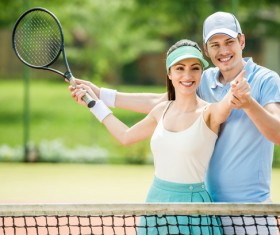 Male coach teaches girls to play tennis Stock Photo