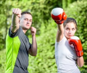 Male coach teaching girl to boxing Stock Photo