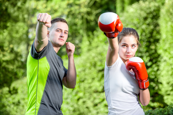 Male coach teaching girl to boxing Stock Photo
