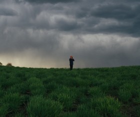Man and alpine cloudscape photo Stock Photo