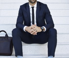 Man sitting on the steps to rest Stock Photo