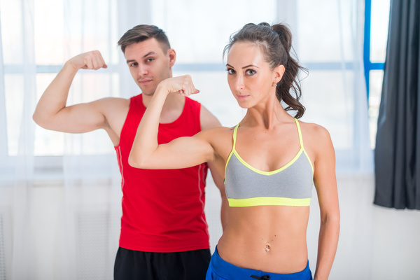 Men and women show biceps Stock Photo