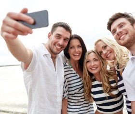 Men and women taking photos with smartphones Stock Photo 01