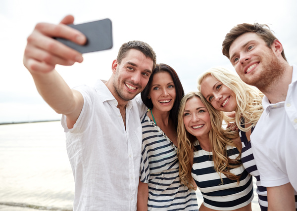 Men and women taking photos with smartphones Stock Photo 01