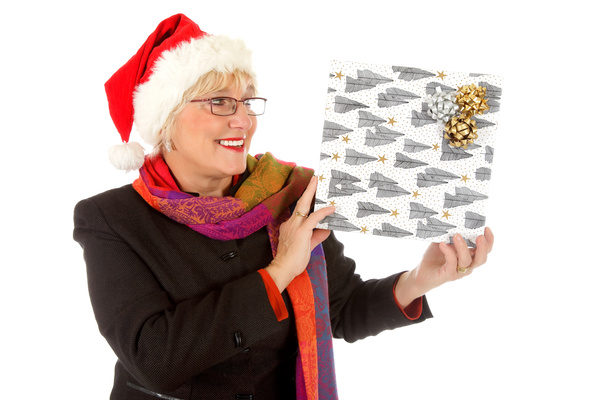 Middle aged woman holding Christmas present Stock Photo