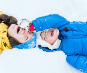 Mother and little boy lying on the snow Stock Photo