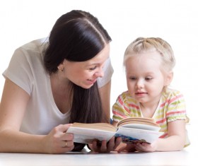 Mother reading to her daughter Stock Photo
