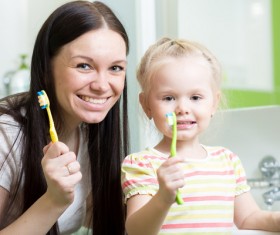 Mother teaching daughter brush teeth Stock Photo 01