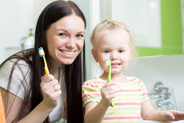 Mother teaching daughter brush teeth Stock Photo 01