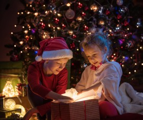 Open presents on Christmas Eve children Stock Photo