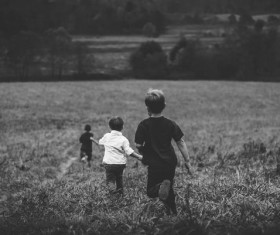 Running children in the fields Stock Photo