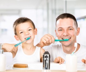 Smiling child brushes his teeth with dad Stock Photo 03