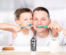 Smiling child brushes his teeth with dad Stock Photo 04