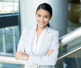 Smiling woman standing on stairs Stock Photo