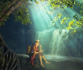 Southeast Asia girl resting under the tree Stock Photo